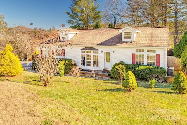 back of house with a lawn and central AC