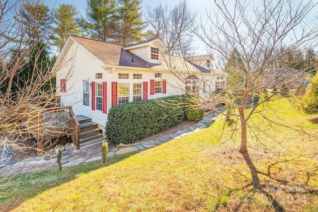 view of home's exterior featuring a yard and a deck