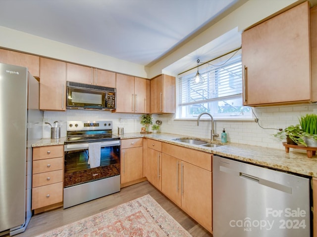 kitchen featuring decorative backsplash, light wood-type flooring, sink, and appliances with stainless steel finishes