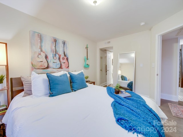 bedroom with wood-type flooring