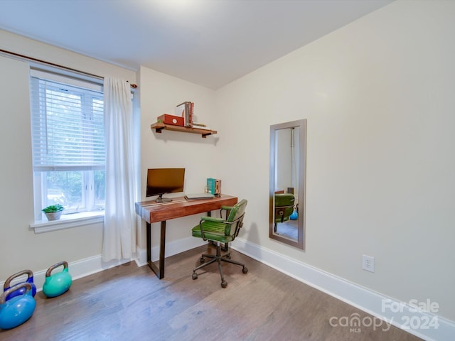 office space with hardwood / wood-style floors and a healthy amount of sunlight