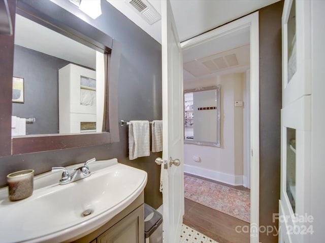 bathroom with hardwood / wood-style floors and vanity