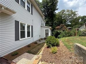 view of property exterior with a lawn