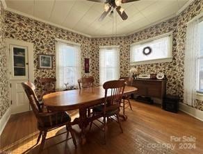 dining space featuring ceiling fan, plenty of natural light, wood-type flooring, and ornamental molding