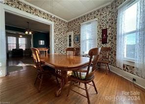 dining area featuring hardwood / wood-style floors and crown molding