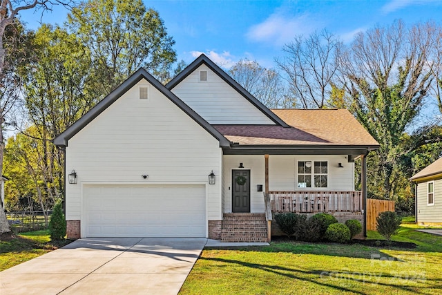 view of front of property with a front lawn, a porch, and a garage