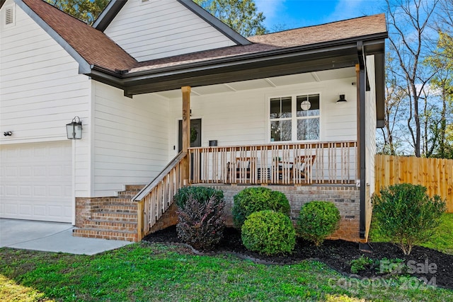 view of front of home featuring a porch and a garage