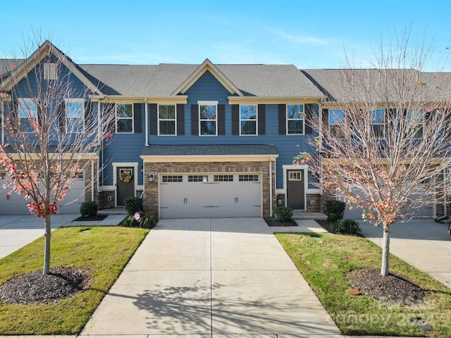 view of front of house featuring a front yard and a garage