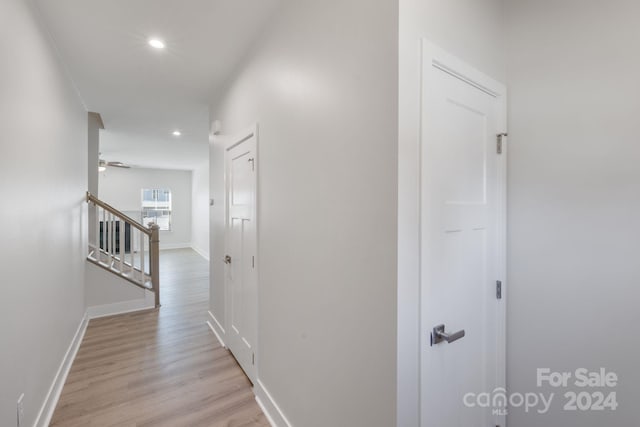 hallway with light hardwood / wood-style floors