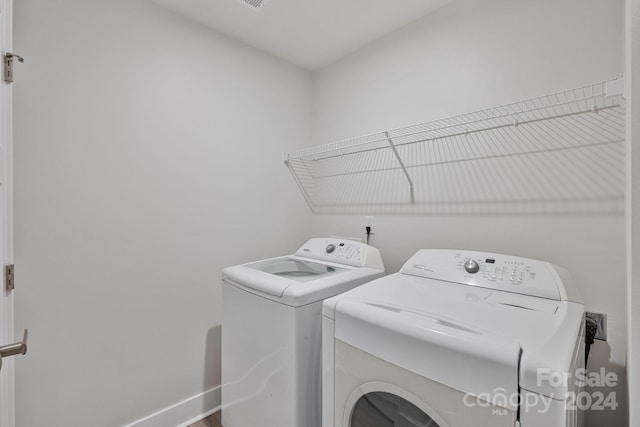 clothes washing area featuring washing machine and dryer