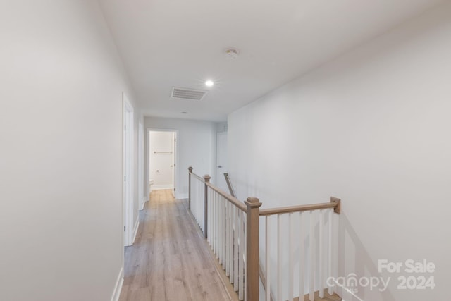 corridor with light hardwood / wood-style flooring