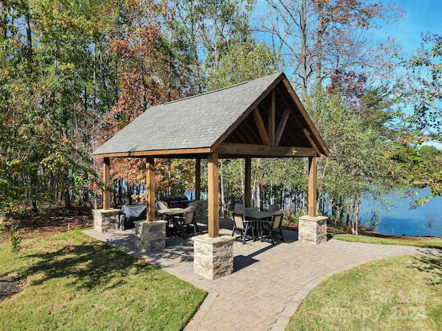 view of patio / terrace with a gazebo and a water view