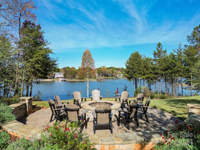 view of patio / terrace featuring a water view and an outdoor fire pit