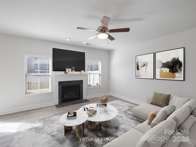 living room with ceiling fan and light hardwood / wood-style flooring