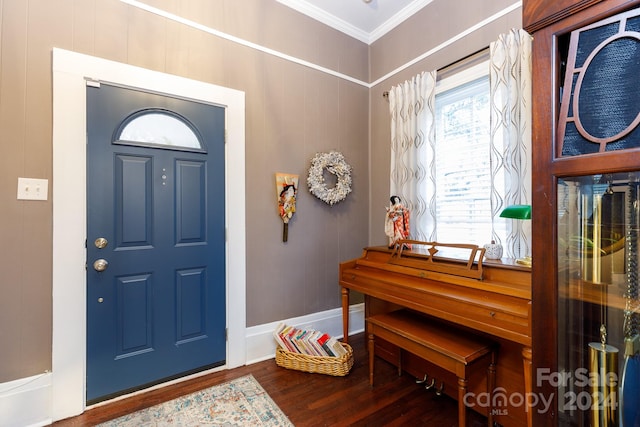 entrance foyer featuring dark wood-type flooring and ornamental molding