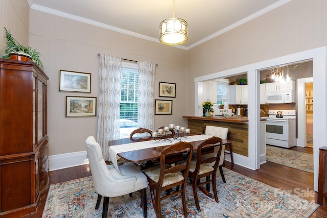 dining area featuring crown molding and dark hardwood / wood-style floors