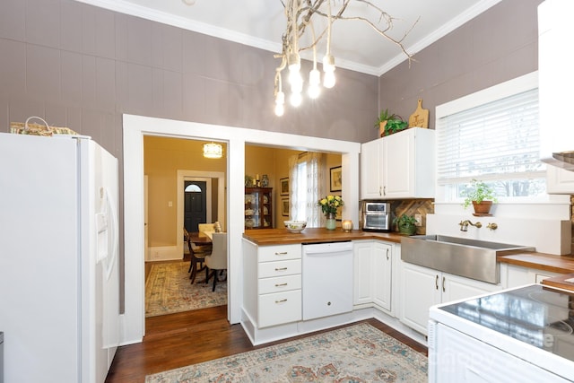 kitchen with dark hardwood / wood-style flooring, white appliances, butcher block countertops, and white cabinetry