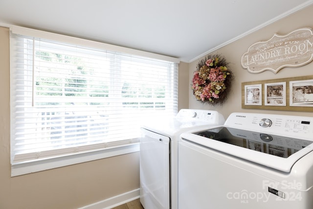 washroom with hardwood / wood-style floors, washing machine and dryer, a wealth of natural light, and ornamental molding