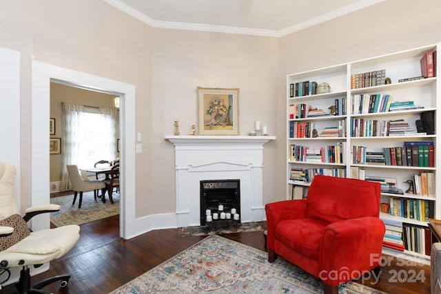 sitting room with dark hardwood / wood-style floors and ornamental molding