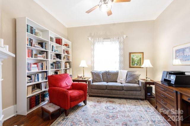 living area featuring ceiling fan, wood-type flooring, and crown molding