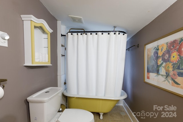 bathroom with tile patterned floors, toilet, and shower / bathtub combination with curtain