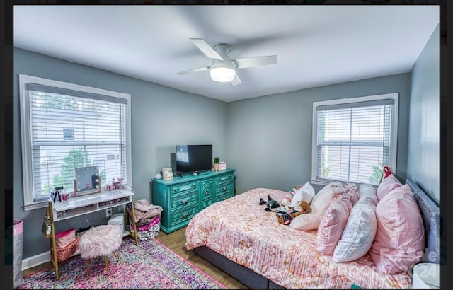 bedroom with hardwood / wood-style floors and ceiling fan