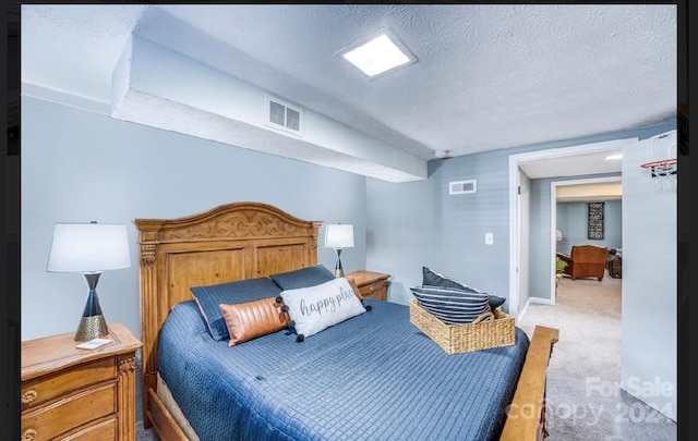 bedroom with carpet and a textured ceiling