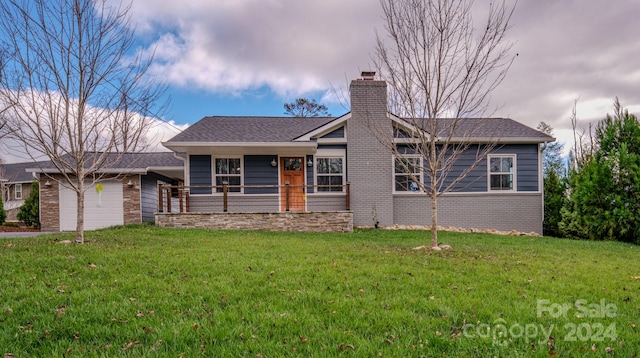 ranch-style home with a front yard and a garage