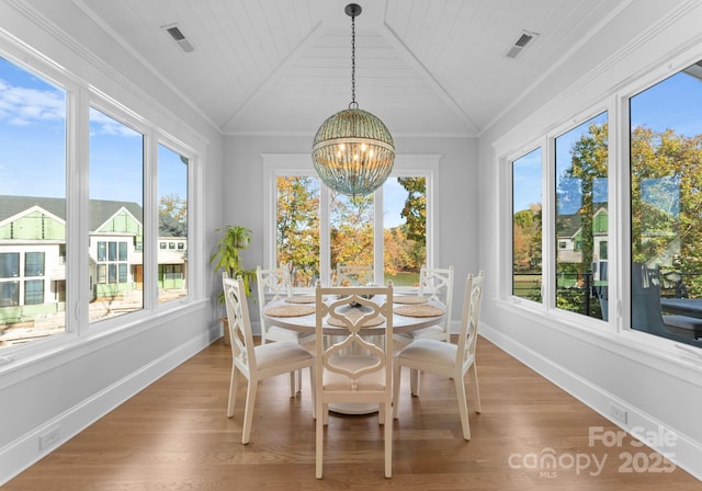 sunroom featuring an inviting chandelier, a healthy amount of sunlight, and wood ceiling