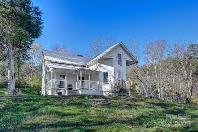 view of front of property with covered porch and solar panels