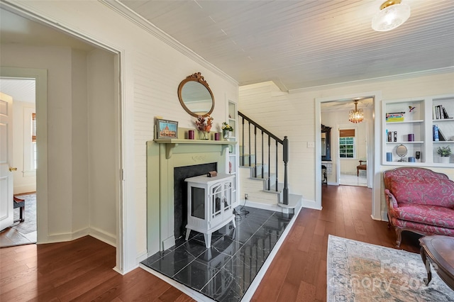 living room featuring crown molding and dark hardwood / wood-style flooring