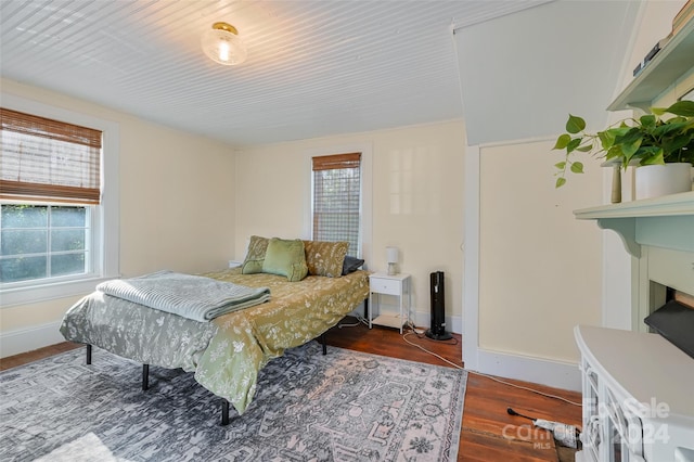 bedroom with dark hardwood / wood-style flooring