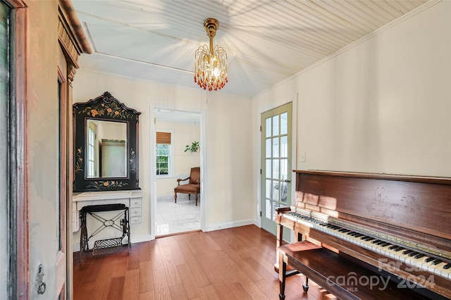 misc room featuring a chandelier, hardwood / wood-style flooring, and ornamental molding