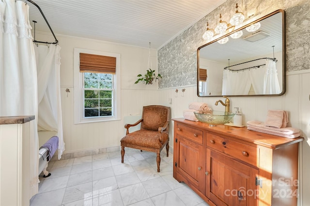 living area with crown molding and sink