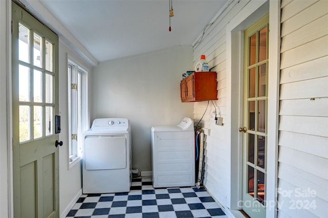 laundry room with a healthy amount of sunlight, cabinets, and washing machine and clothes dryer