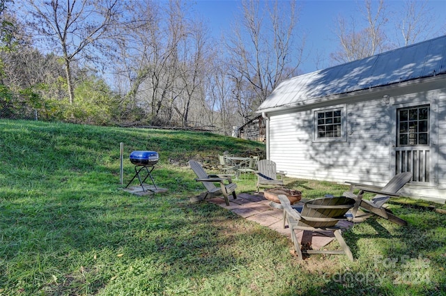 view of yard with a fire pit