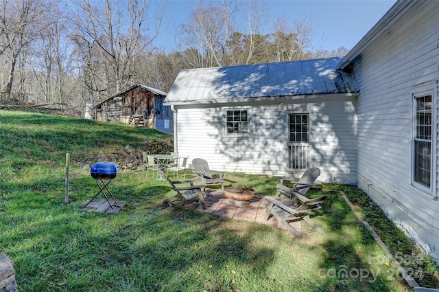 view of yard with a patio area and an outdoor fire pit