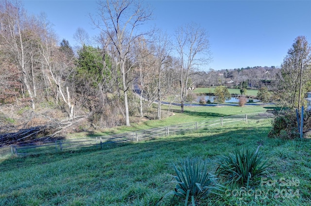 view of yard featuring a rural view and a water view