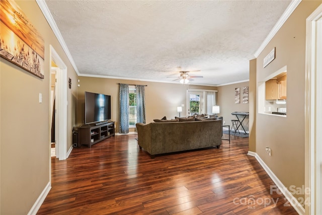 living room featuring a textured ceiling, ceiling fan, crown molding, and dark wood-type flooring