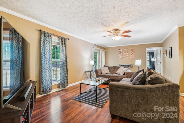 living room featuring crown molding, ceiling fan, dark wood-type flooring, and a textured ceiling