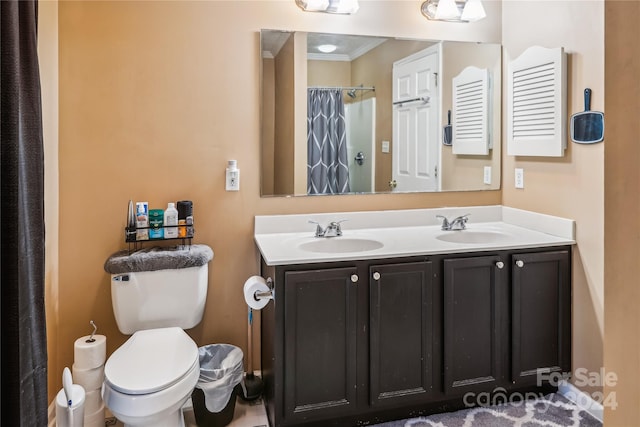 bathroom with vanity, toilet, curtained shower, and ornamental molding