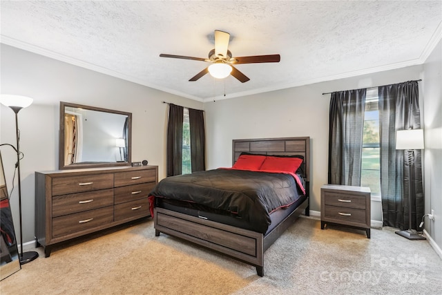 carpeted bedroom with ceiling fan, ornamental molding, and a textured ceiling