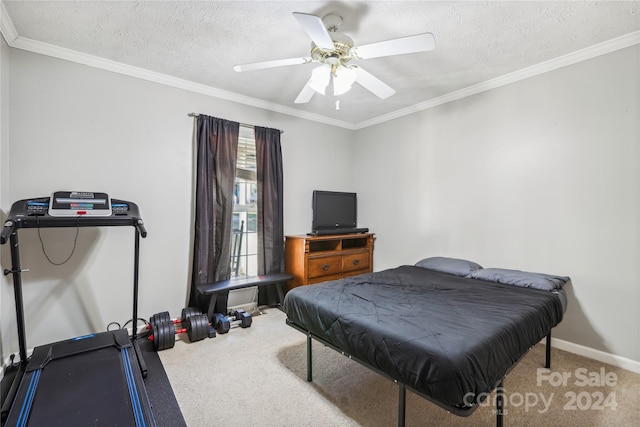 bedroom with carpet flooring, ceiling fan, ornamental molding, and a textured ceiling