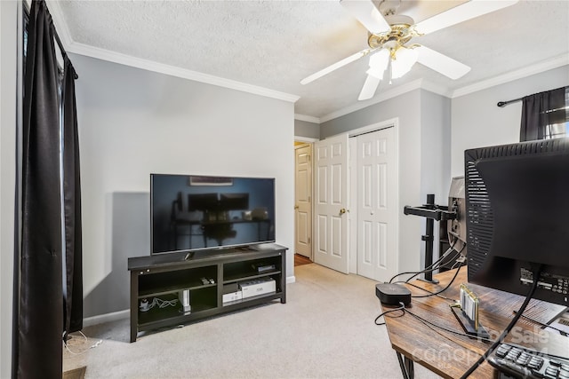 office area featuring ceiling fan, crown molding, and light carpet