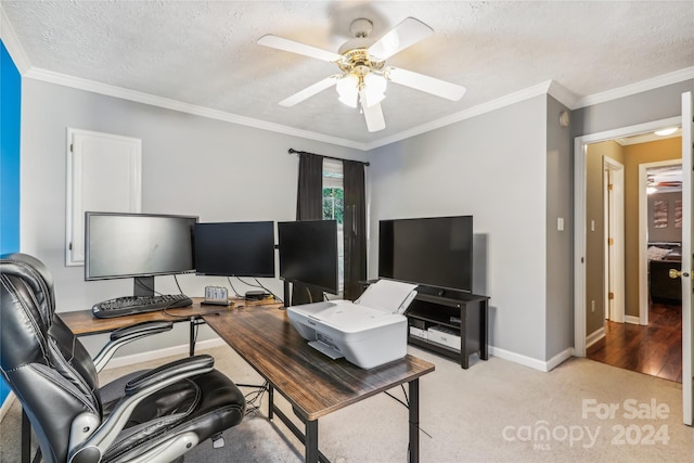 carpeted home office featuring a textured ceiling, ceiling fan, and ornamental molding