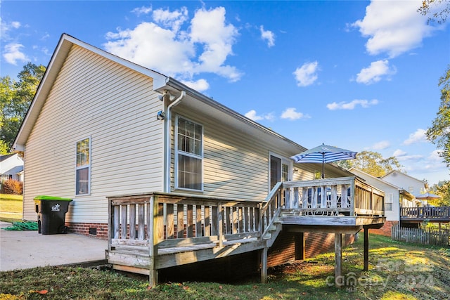 back of house with a patio area and a deck