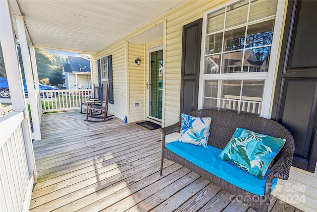 wooden terrace featuring covered porch