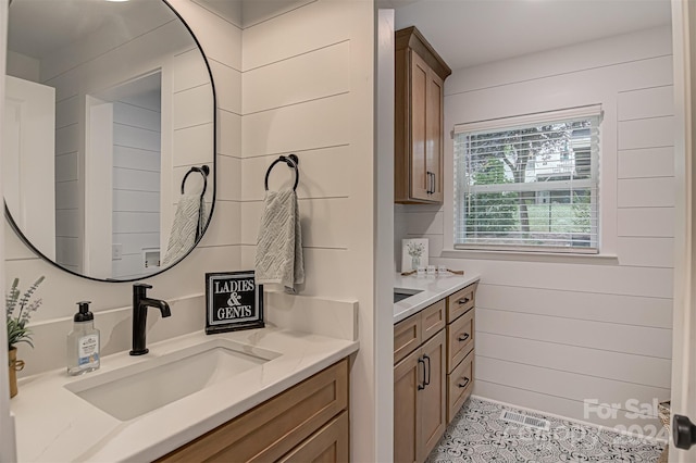 bathroom featuring vanity, tile patterned floors, and wooden walls