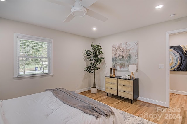 bedroom with hardwood / wood-style floors, ceiling fan, a spacious closet, and a closet