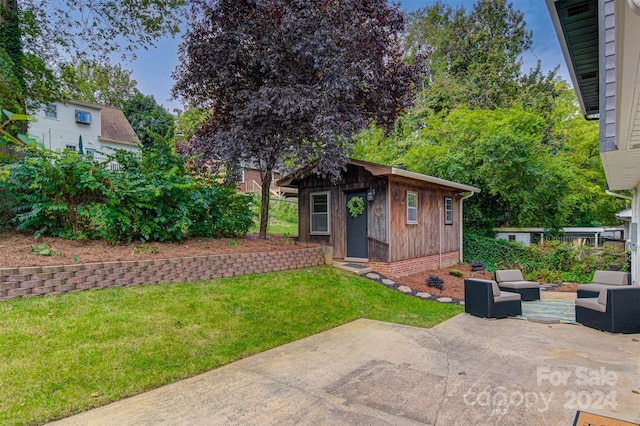 view of yard with an outbuilding, outdoor lounge area, and a patio